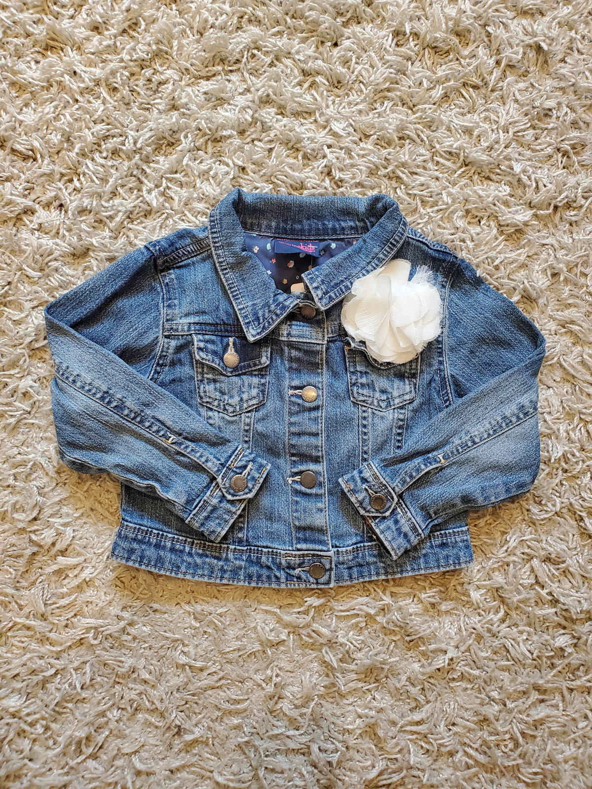 Oshkosh distressed denim jacket. Cute flower embellishment. Size 4T. Excellent used condition.