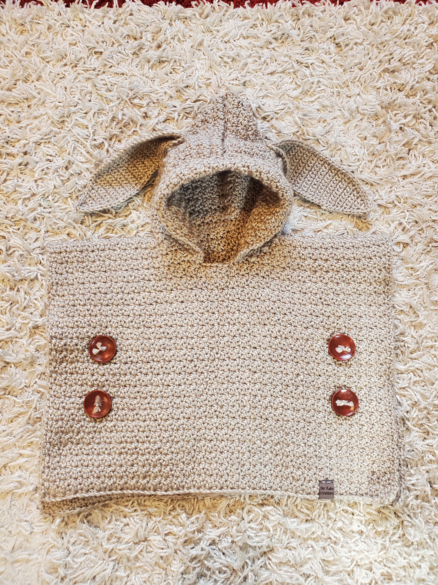 Der Rabe Creations hooded poncho. Size 0-6 months. Handcrafted. New.